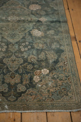 Distressed aqua teal floral patterns, worn border, and fringe on a vintage Kashan rug.