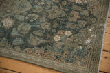 Distressed vintage Kashan rug corner, showing visible foundation, aqua floral border, and fringe.