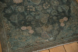 Vintage distressed Persian Kashan rug corner with textured aqua teal floral field.