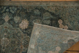 Dark aqua teal distressed vintage Kashan rug folded, revealing light blue foundation.