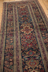 Intricate navy blue, cochineal red, and bronze alternating Kerman rug patterns.