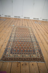 Early 20th century Persian Haji Jalili Tabriz runner: repeating terra cotta boteh, navy, teal, and charcoal borders.