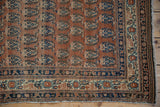 Antique Haji Jalili Tabriz runner corner displaying terra cotta and navy boteh pattern, ornate border.