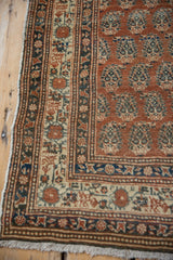 Antique Haji Jalili Tabriz runner corner, pale terra cotta field, boteh design, navy bordered fringe.
