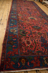 Vintage Bijar runner with raspberry red palmette field and indigo blue border.