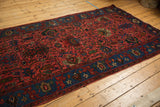 Section of a vintage Bijar runner, showing raspberry red palmettes and indigo blue floral border.