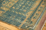 Distressed Belouch carpet with repeating geometric gul motifs, cobalt and sand abrashes.