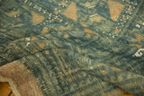 Hand-knotted Belouch carpet's sand plain weave foundation, fringed edge, and worn pile.
