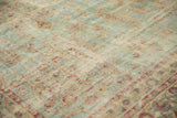 Intricate floral motifs in cochineal red and beige on distressed powder blue Kerman carpet.