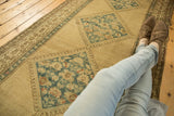 Distressed Serab runner's sky blue floral diamond medallion on a textured beige field.