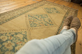 Distressed Serab runner, abrashed beige field, blue diamond medallions, red floral motifs.