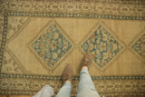 Distressed vintage Serab runner with sky blue floral diamond medallions, showing even wear.