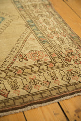 Distressed Serab runner corner with beige field, muted geometric borders, and even pile wear.
