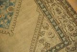 Abrash on beige field and blue diamond motif of a distressed Serab runner.