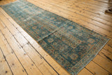 Distressed Mahal runner end displaying worn ocean blue-green field and terra cotta palmette borders.