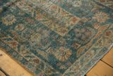 Distressed vintage Mahal runner edge with ocean blue-green and terra cotta floral motifs.