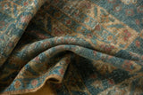 Decorative worn pile of a distressed Mahal runner, ocean blue-green, terra cotta, and ivory patterns.