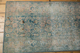 Distressed pile detail of the vintage Persian Meshed runner, showing worn ocean green motifs and foundation.