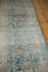 Worn texture of a distressed vintage Persian Meshed runner, revealing soft ocean green, blush, and visible foundation.