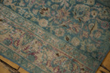 Textured border detail of a distressed Meshed runner with ocean green, blush, and visible wear.