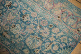Distressed Meshed rug section, ocean green and blush scrolling palmettes, worn pile revealing foundation.