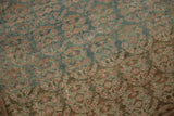 Distressed texture of a vintage Malayer runner with faded green, blue, and blush red botehs.