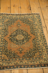Hand-knotted antique Persian Tabriz rug with scalloped navy floral medallion and terra cotta field.