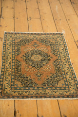 Secured antique ivory fringe and blue floral border of the Persian Tabriz rug.