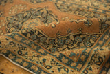 Antique Persian Tabriz hand-knotted pile texture with terra cotta and blue floral motifs.
