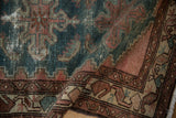 Distressed wide banded border of the vintage Hamadan rug with aubergine and beige botehs.