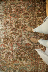 Worn distressed Baktiari rug, wine red, blue tree of life motifs, palmettes, and shoes.