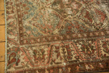 Worn texture and muted colors on the vintage Baktiari rug's distressed palmette border.