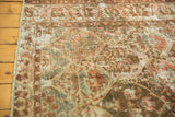 Distressed Baktiari rug detail: textured pile, mostly even wear, wine red and slate blue palmettes.