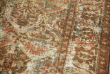Distressed vintage Baktiari rug with worn classical motifs in blush, ivory, slate blue.