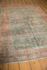 Distressed vintage Malayer rug field with blush red palmettes and foundation showing through.