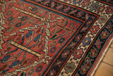 Corner detail of vintage Kurdish carpet, showing madder root red field, trellis motifs, and patterned borders.