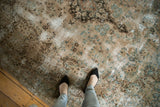 Distressed Kerman carpet's worn texture, faded European floral vinery in beige, ocean blue, brown.