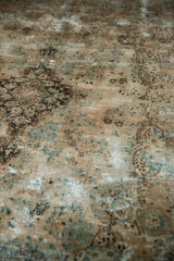 Distressed texture and faded European stylized floral vinery on vintage Kerman carpet.