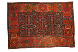 Antique Bijar rug, navy blue Herati field, brick red garden motif border, and visible wear.
