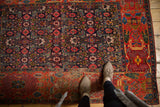 Antique Bijar rug's intricate Herati and garden motif with navy, brick red, and mallard green.