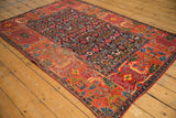 Antique Bijar rug's hand-seamed border, showing brick red panels and garden style motifs.