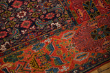 Fragmented antique Bijar rug showcasing rich navy Herati and brick red garden motifs.