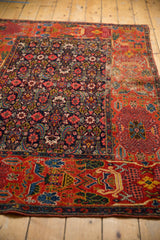 Hand-seamed junction of navy Herati and red early garden design motifs, antique Bijar.