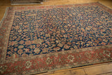 Intricate navy blue field and madder root red border of the vintage Heriz carpet.