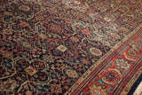 Detail of vintage Persian Mahal carpet's navy, cherry red, ivory trefoil lattice with soft wear.