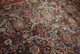 Vintage Mahal carpet detail: navy, red, beige trefoil lattice pattern with visible foundation wear.