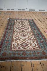 Angled perspective of a vintage Hamadan runner showing its full medallion lattice pattern.
