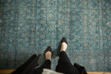 Distressed traditional Tabriz carpet with teal blue and faded red Herati motifs.