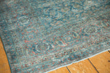Distressed vintage Tabriz carpet with sapphire blue Herati motif, red turtle border, and even wear.