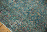 Distressed vintage Tabriz carpet corner, with Herati motif in time-softened blue and red tones.